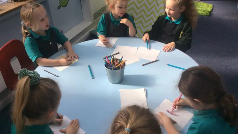 Six younger children starting to write.