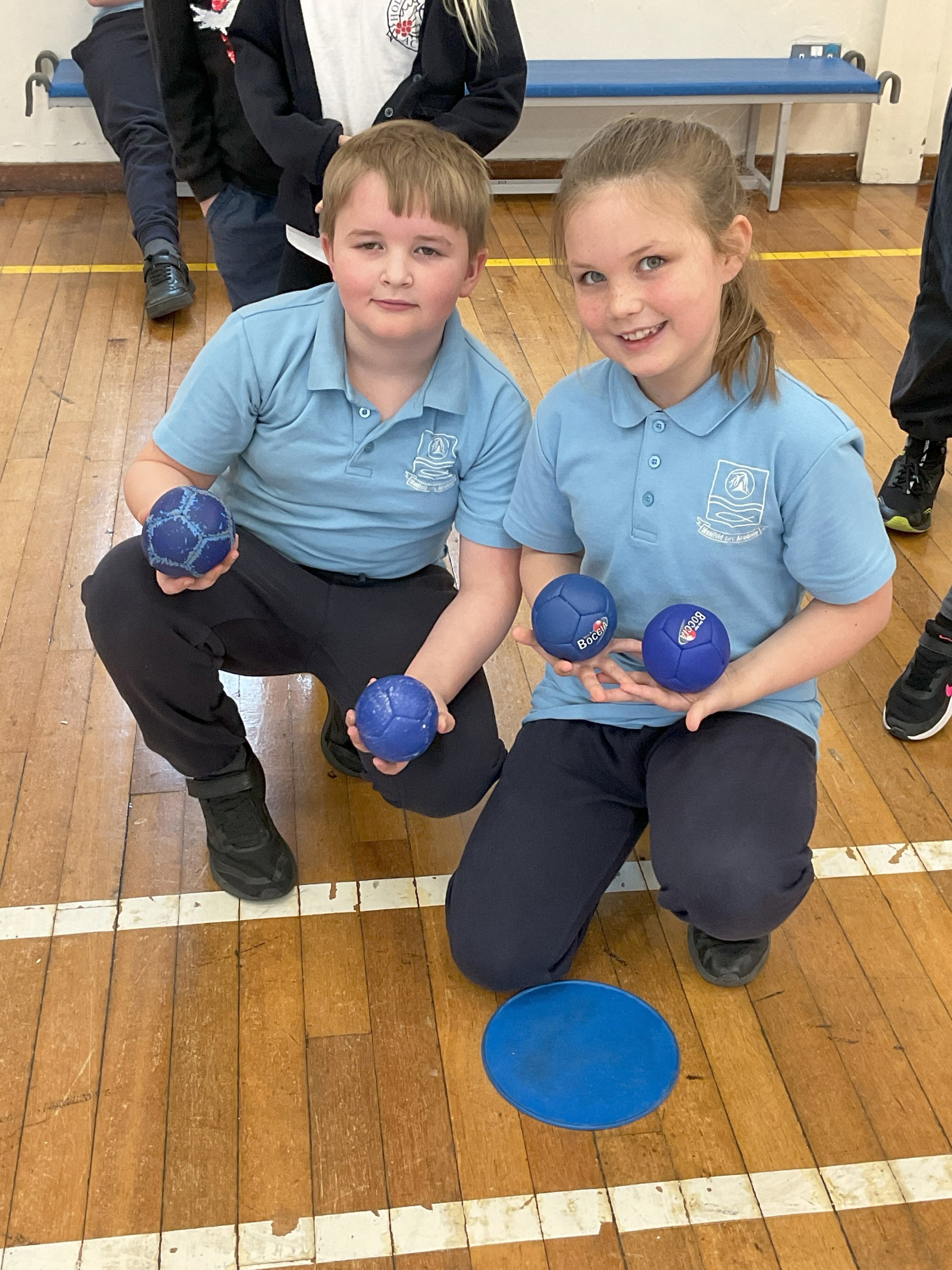 Two children holding boccia balls.