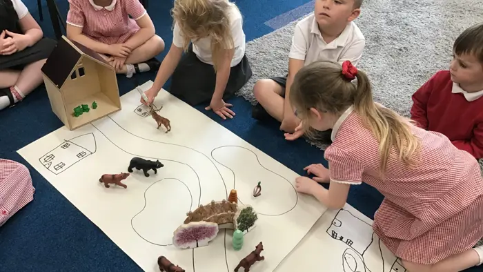A group of children designing a farm.