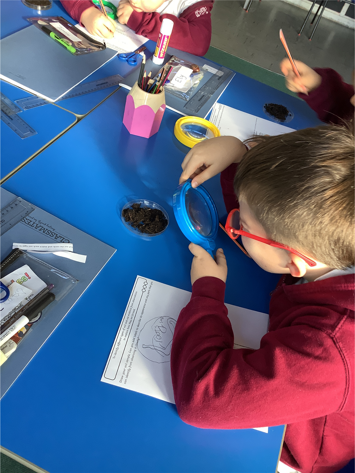 Child using a magnifying glass.