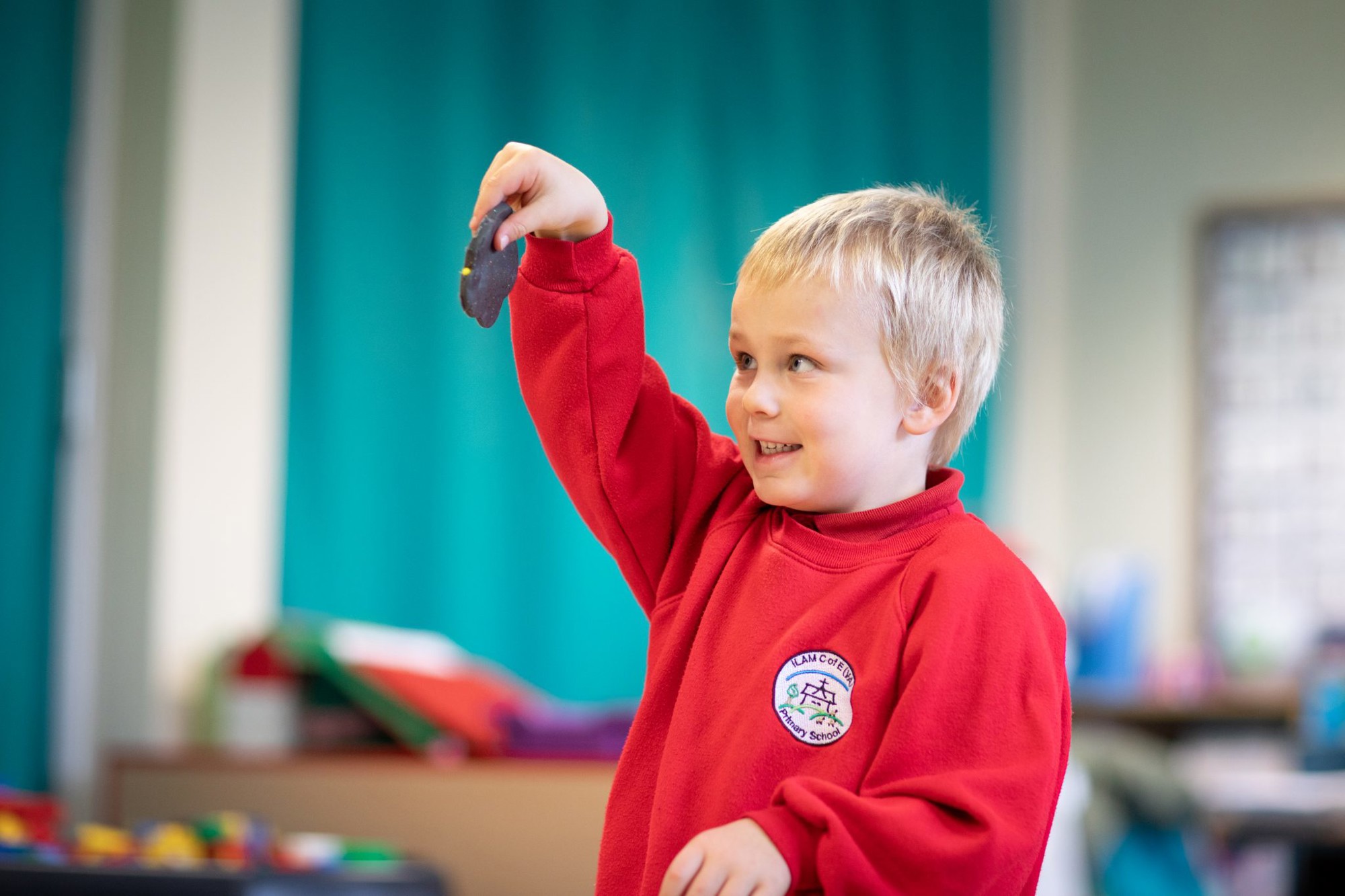 A child investigating and smiling.