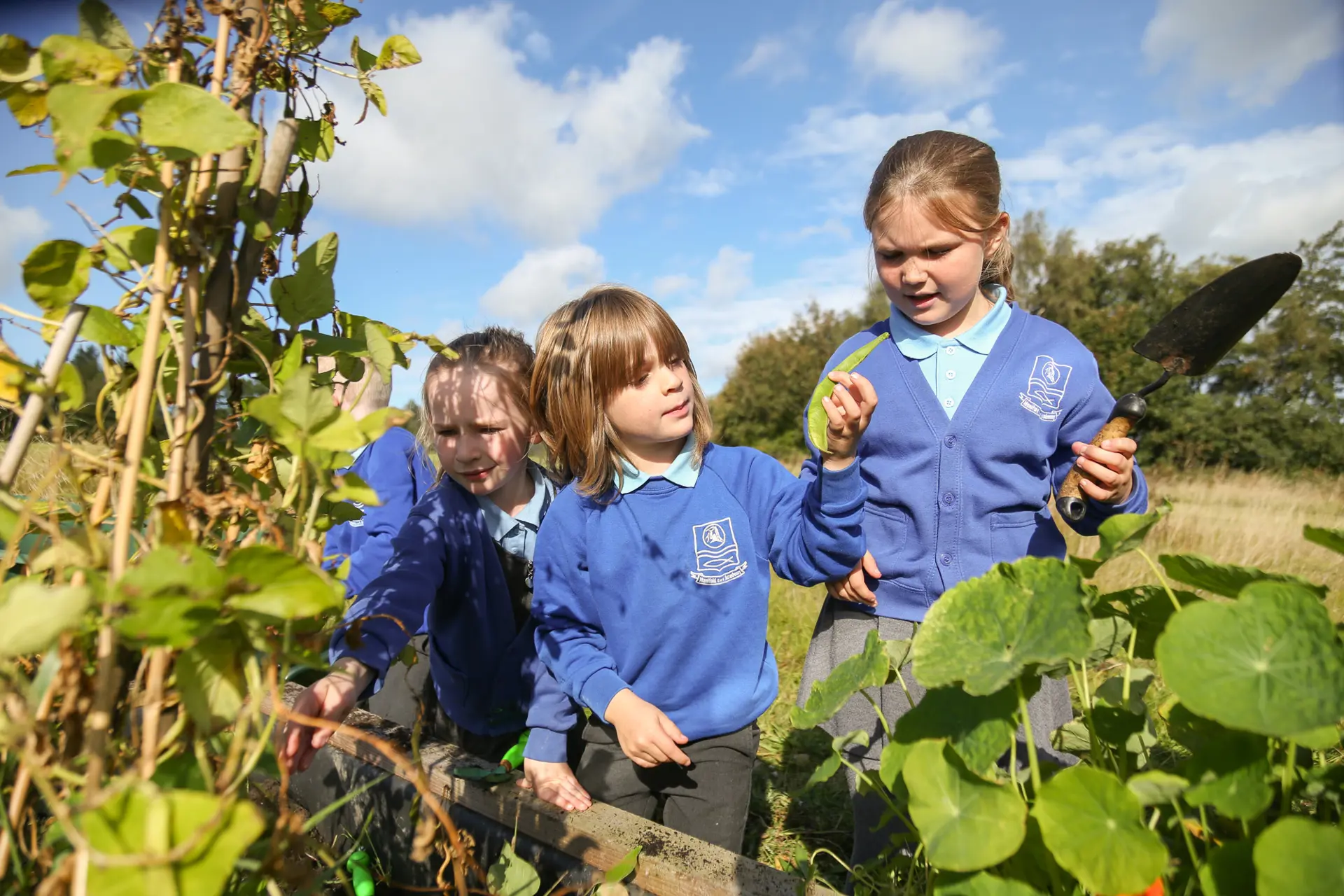 Three children gardening.