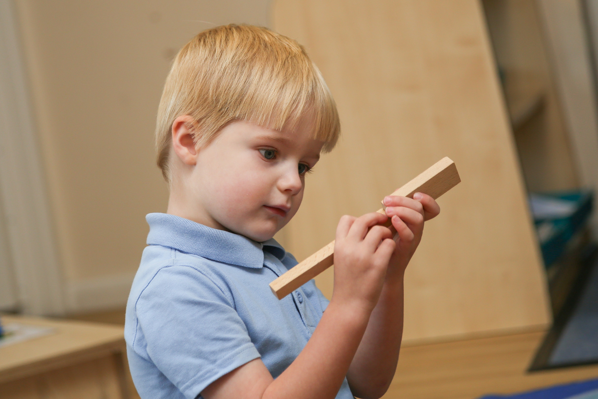 Younger child holding blocks.
