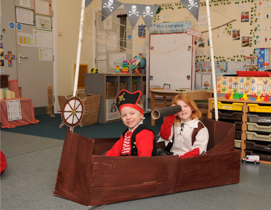 Younger children role-playing in a pirate ship.