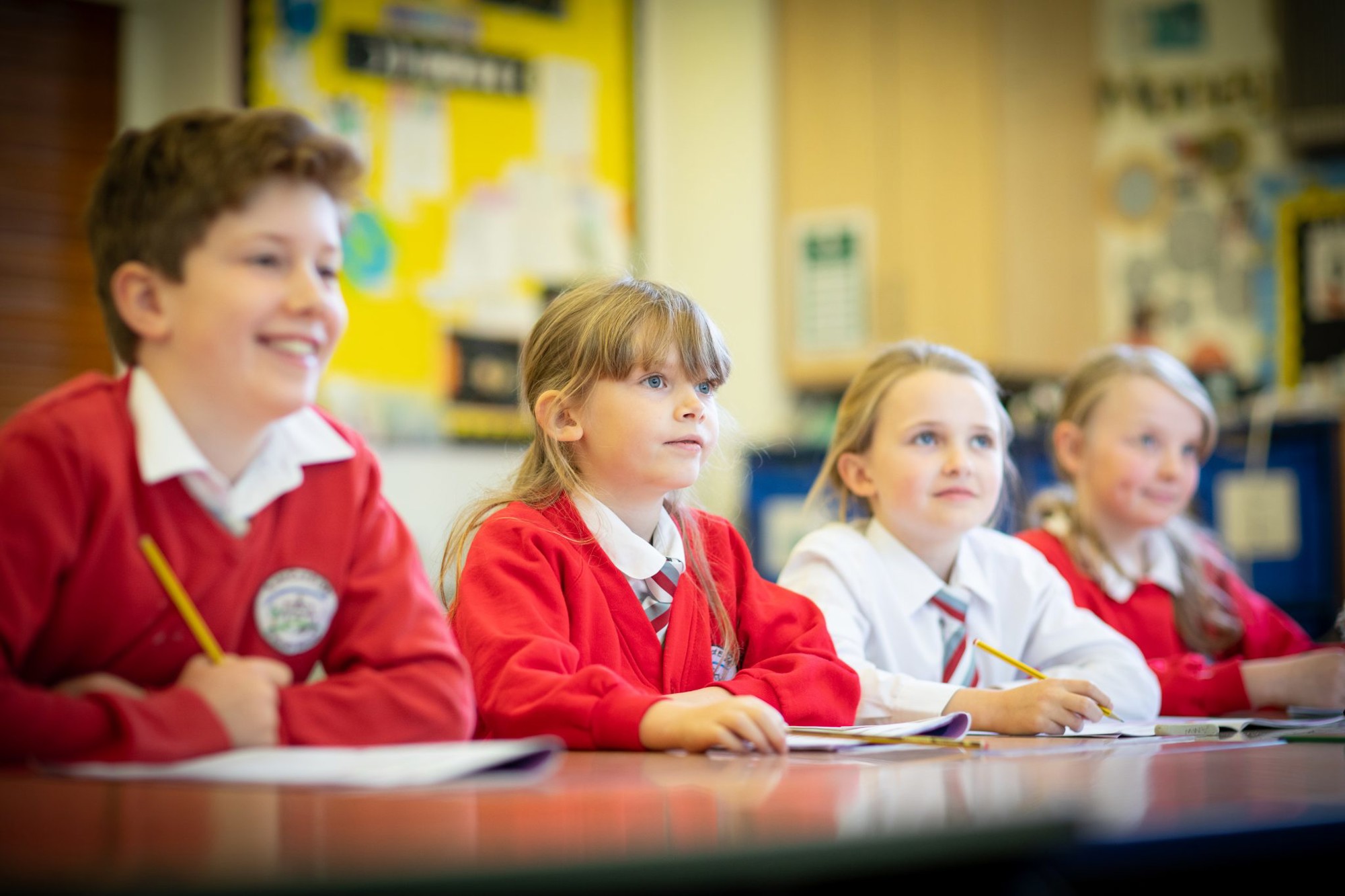 Four children engaged in learning during a lesson.