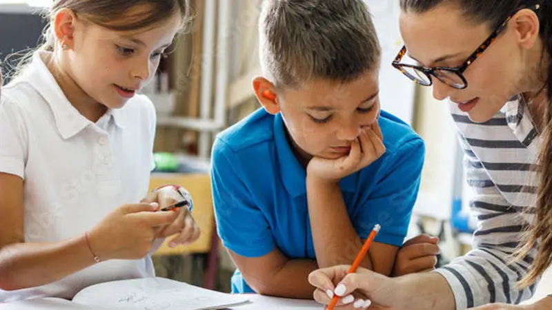 Teacher writing with four children.