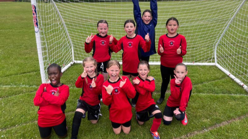 St. John's CE Primary School - girls football team smiling.