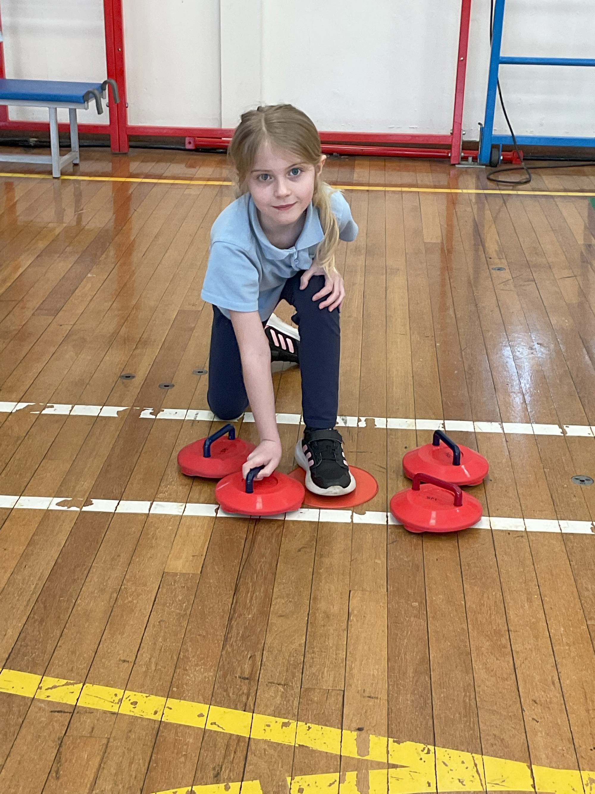 Child with dry-floor curling stones.