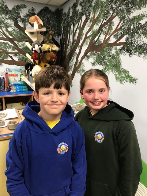 Two children smiling to the camera.