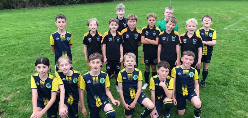 Three TMPF Trust schools smiling together after a football match.