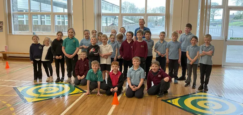Group of children from several rural schools smiling together.