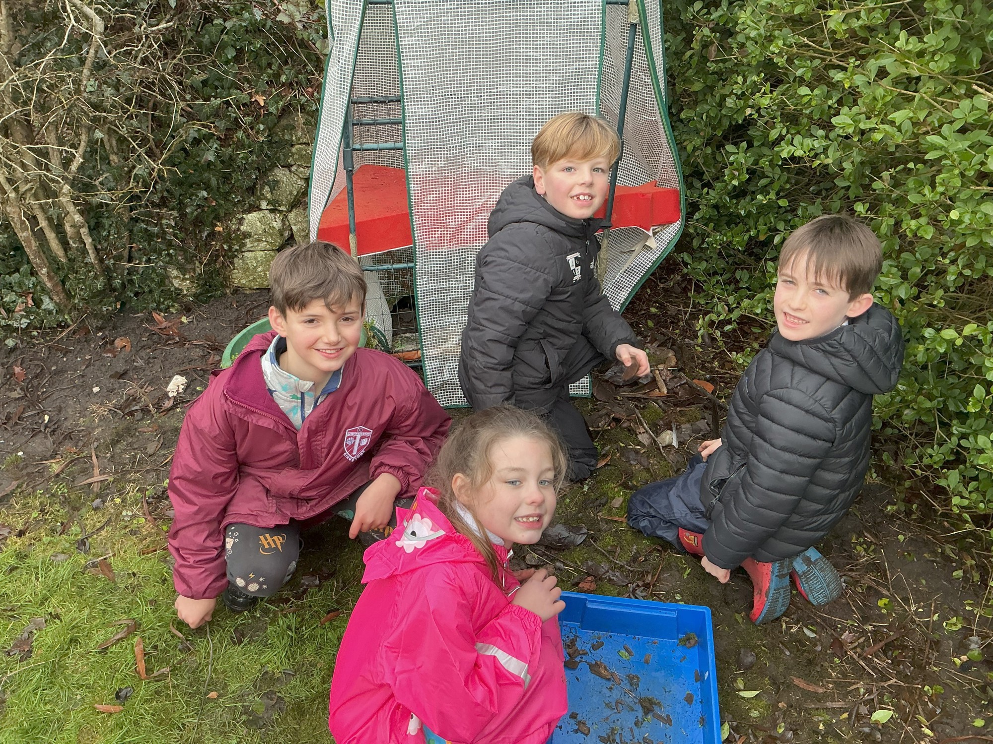 Four children learning outside.