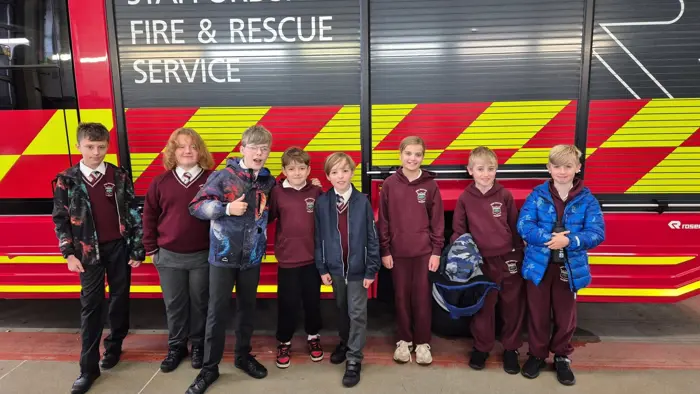 Children standing in front of a fire engine.