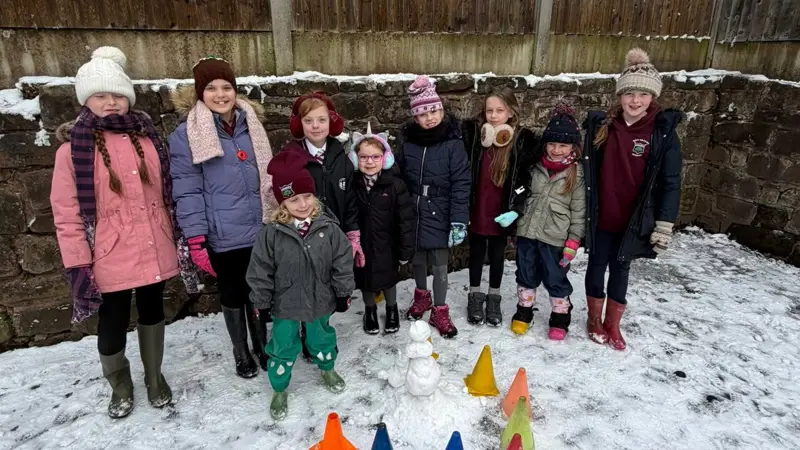 Children building a snowman.