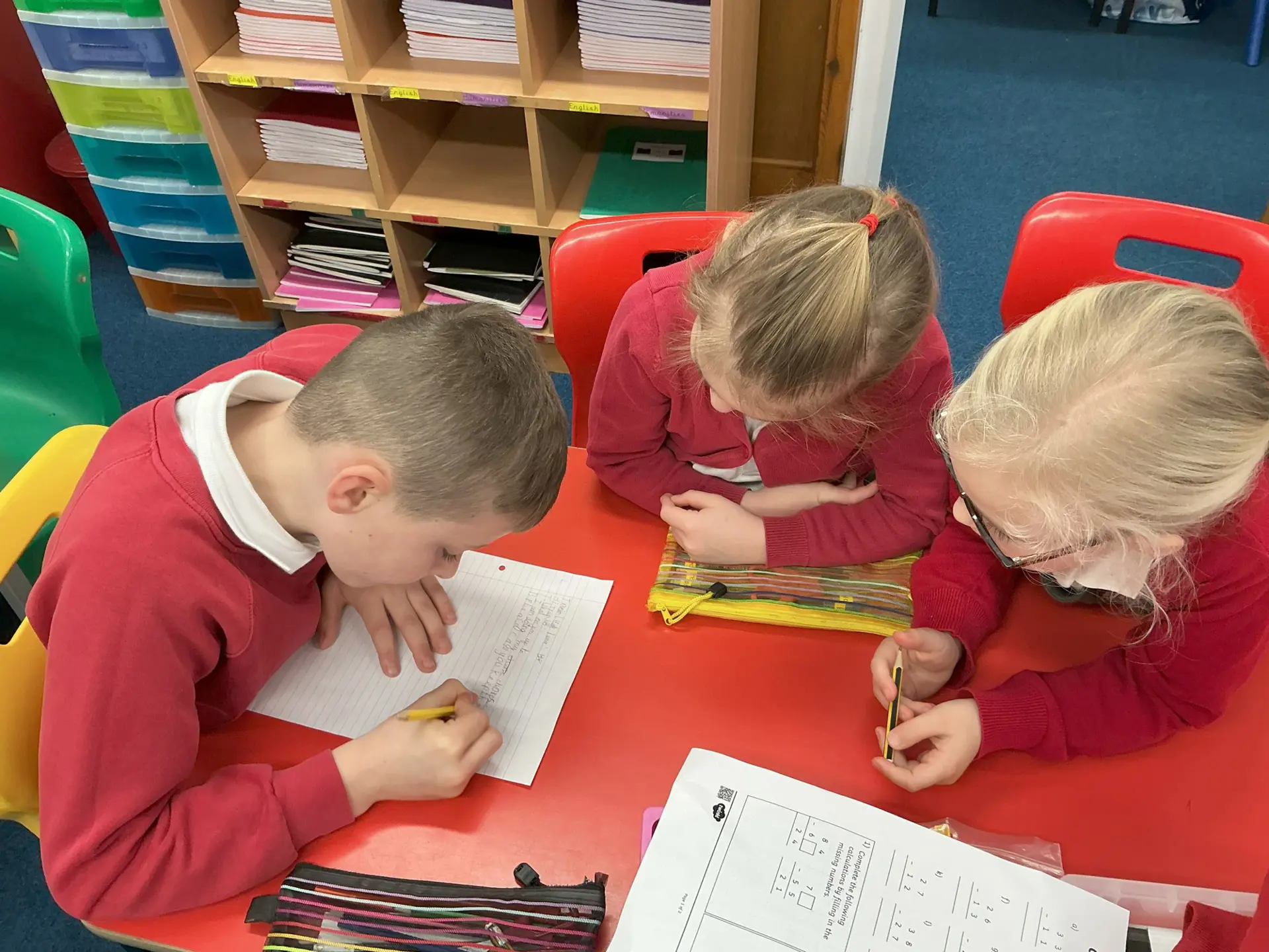 Three children learning together in class.