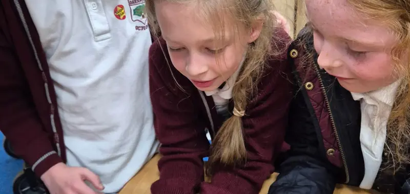 Three children with a tarantula.