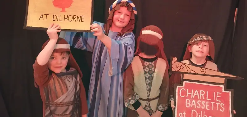 Four children dressed as shepherds and innkeepers