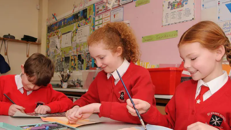 Three children in an art lesson.