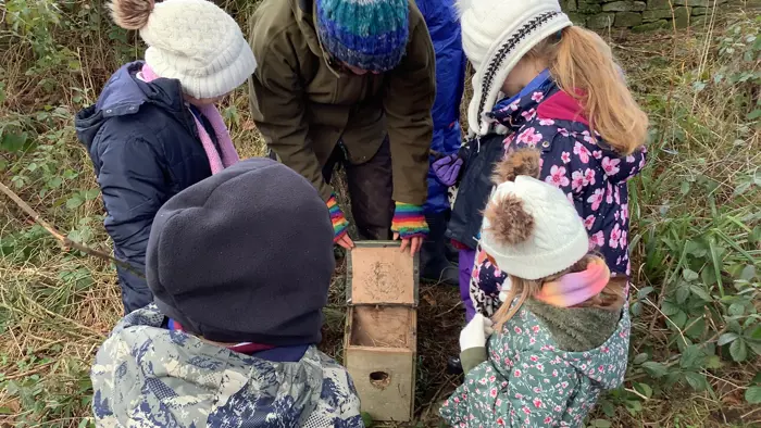 Children learning during a forest school session.