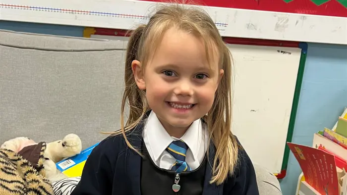 Young child smiling to camera.