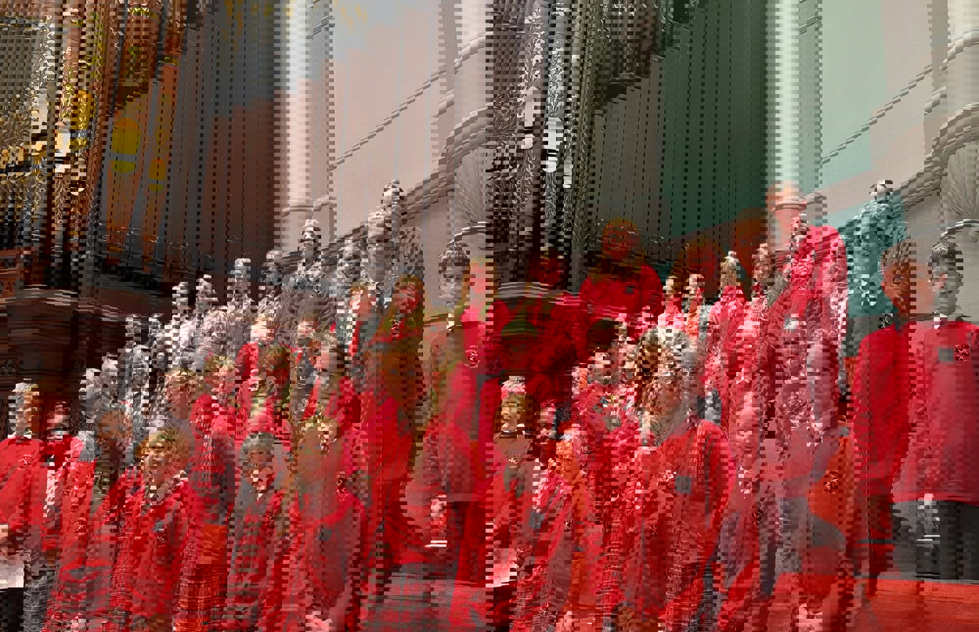 Choir of children singing on stage in a theatre.