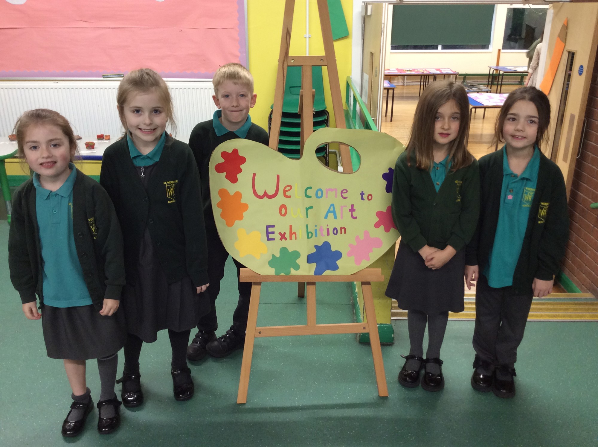 Group of children with a 'Welcome' sign.