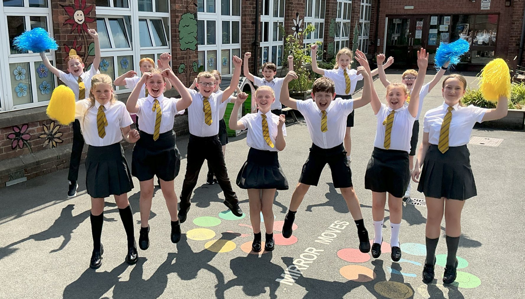 Children jumping to celebrate school's success