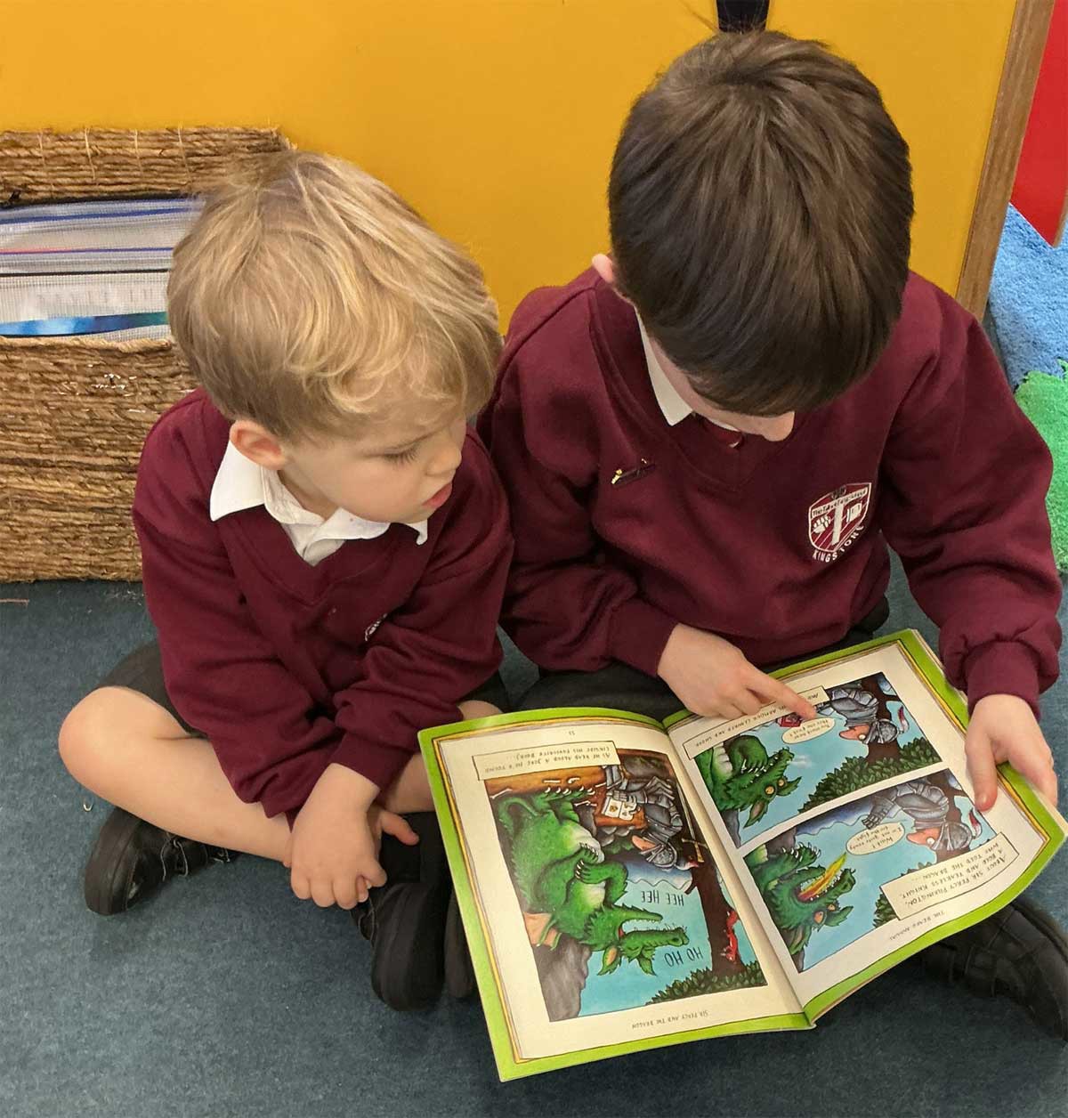 Two children sharing a book.