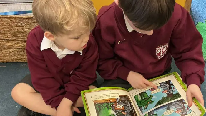 Two children sharing a book.