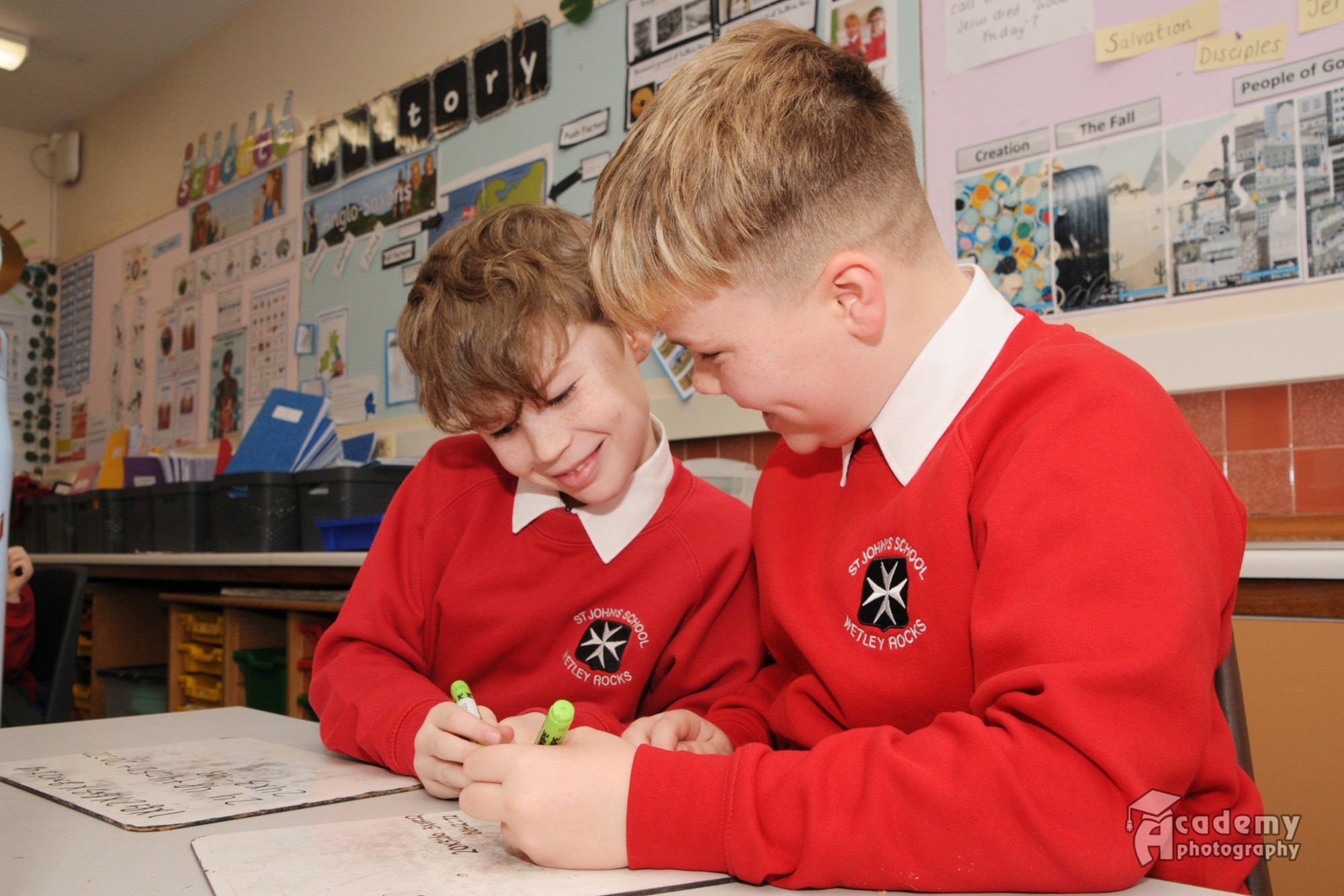 Two boys writing.