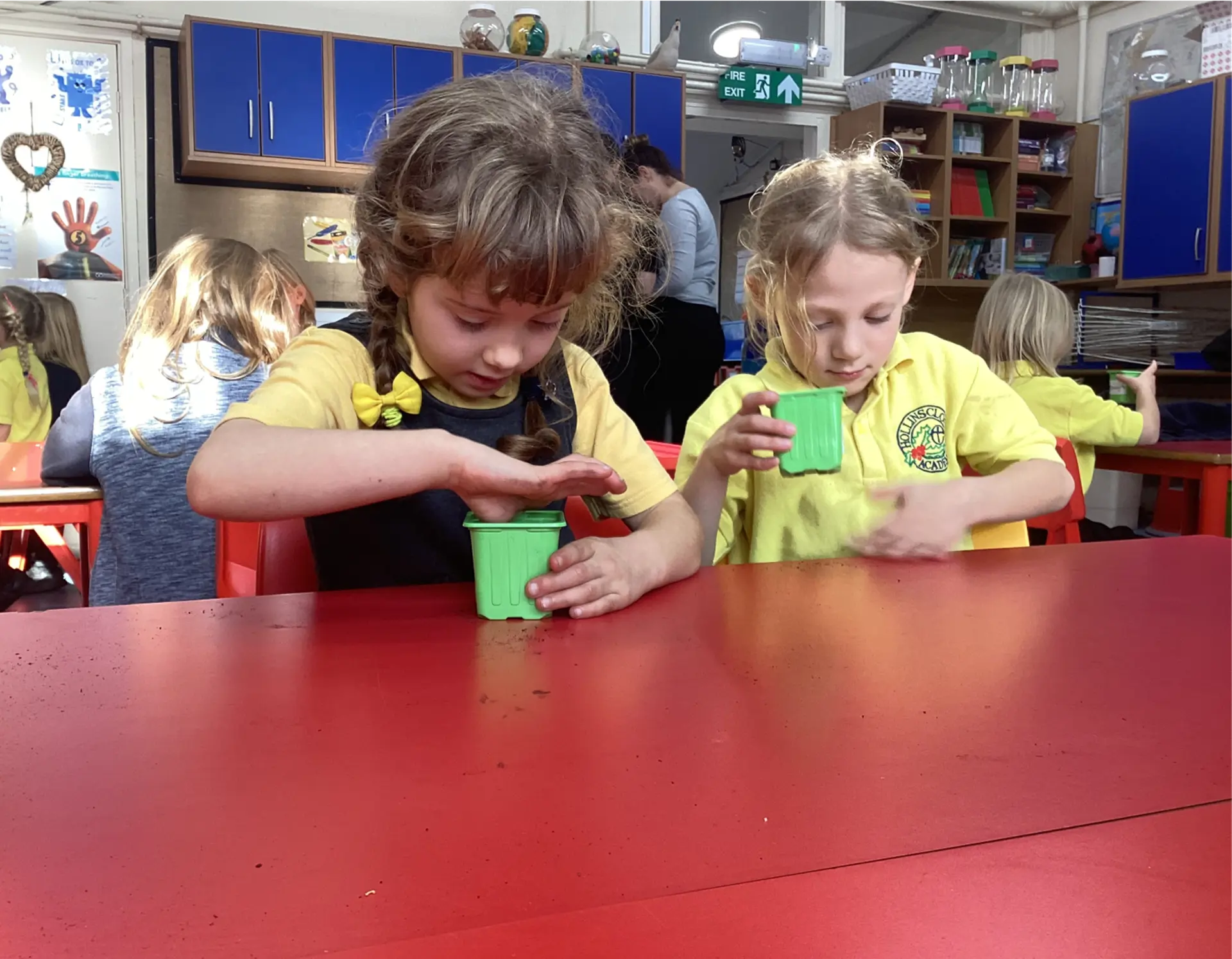 Two children planting seeds in a Science lesson.