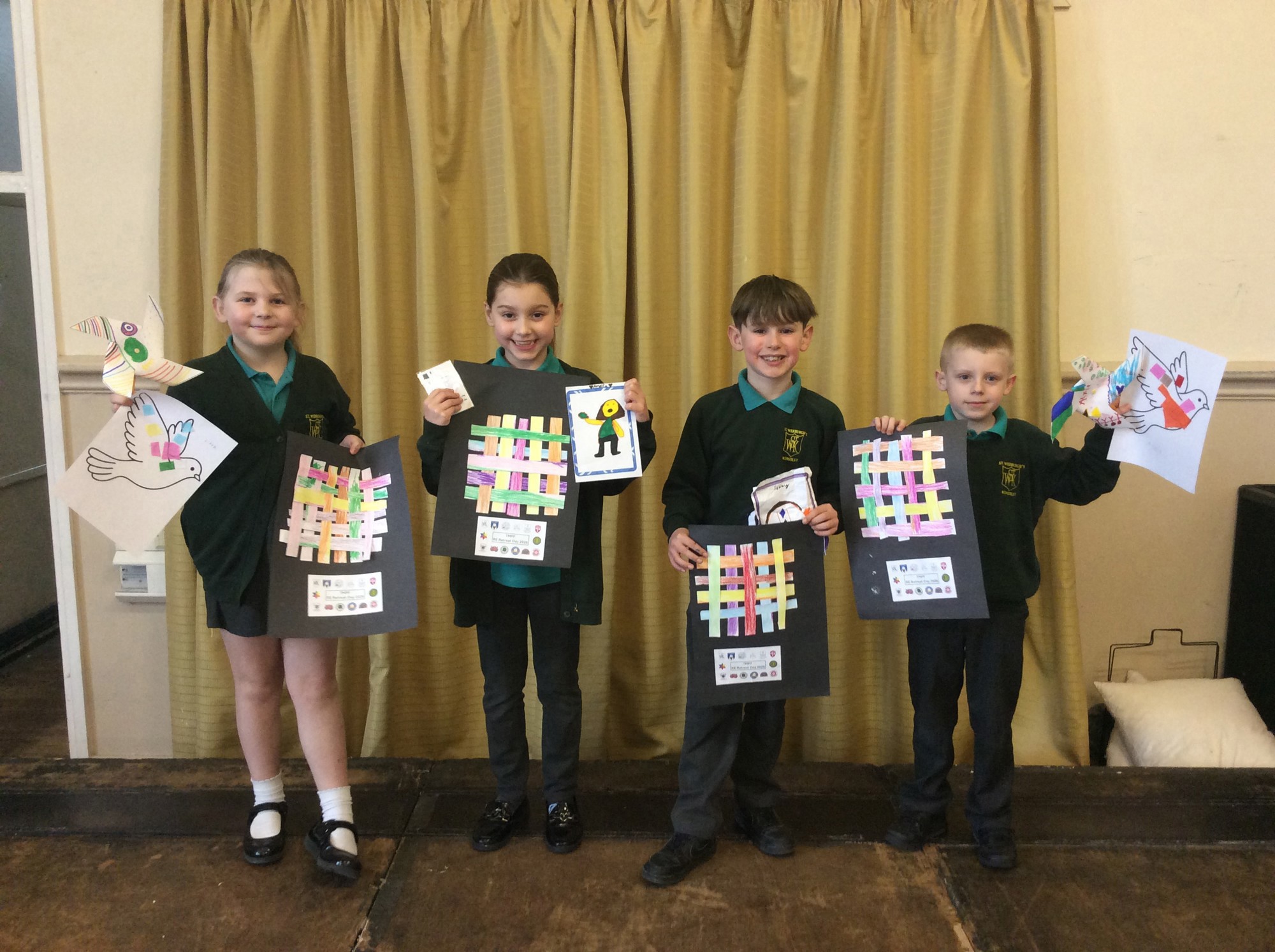 Four children holding artwork focusing upon peace and being mindful.