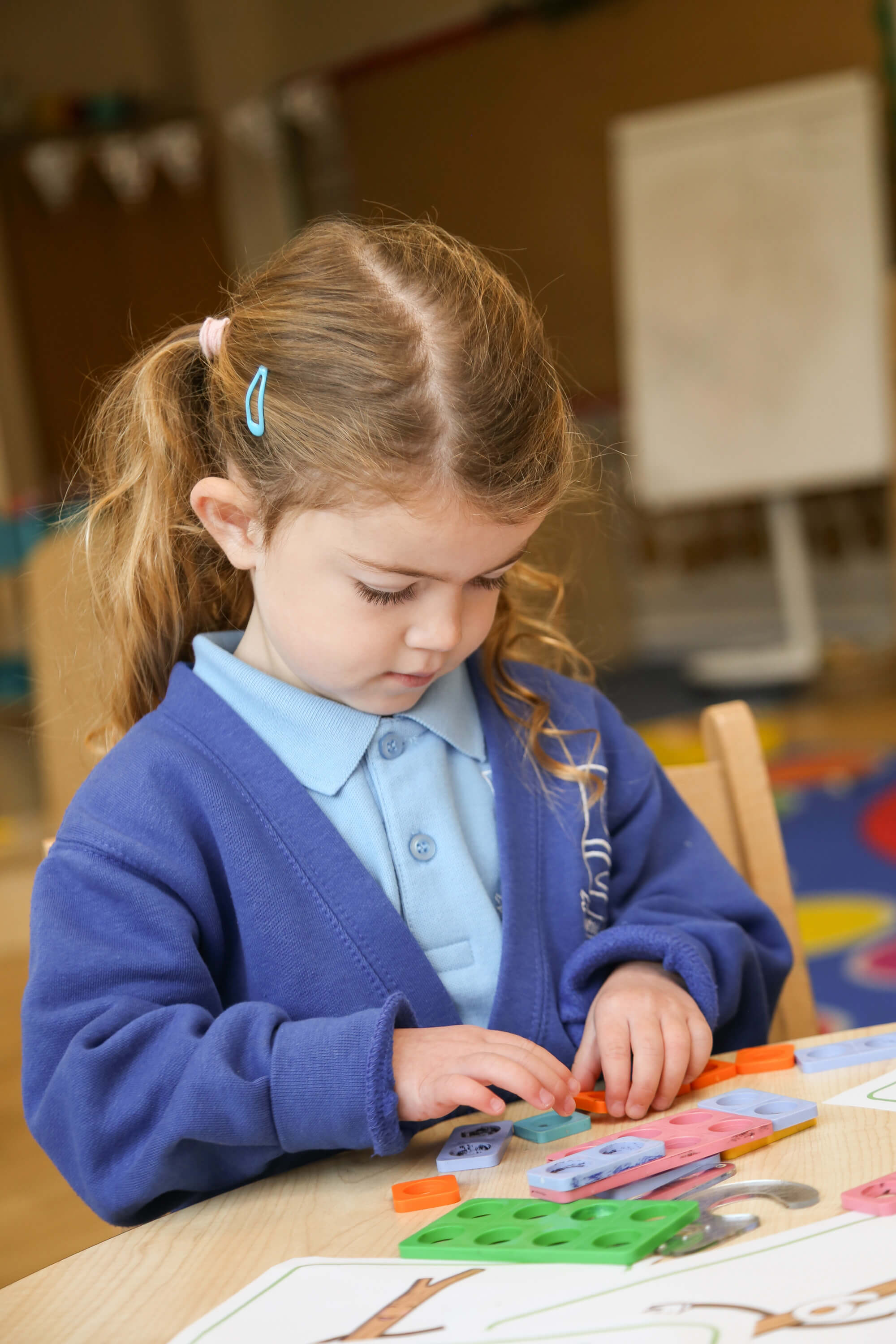 Child using Maths apparatus.